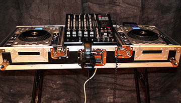 Dual turntable dj setup with mixer on a table.